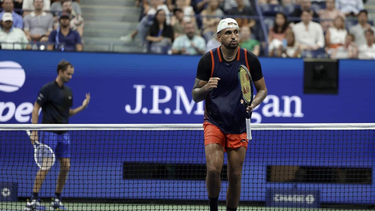 Nick Kyrgios, of Australia, celebrates winning a point against Daniil Medvedev, rear, of Russia, during the fourth round of the U.S. Open tennis championships