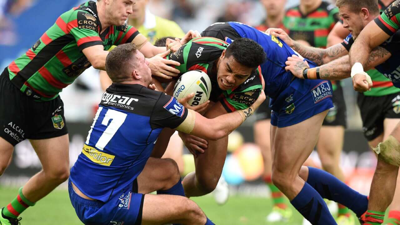 Hymel Hunt of the Rabbitohs is tackled by Adam Elliot