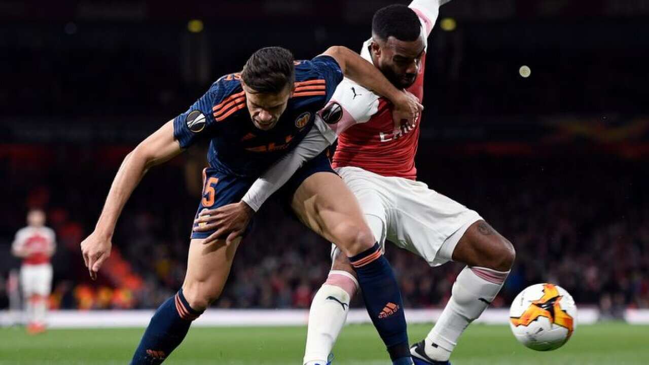 Arsenal's Alexandre Lacazette (R) fights for ball with Valencia's Lato (L) during the UEFA Europa League semi final first leg soccer match between Arsenal FC and Valencia CF in London, Britain, 02 May 2019. EPA/
