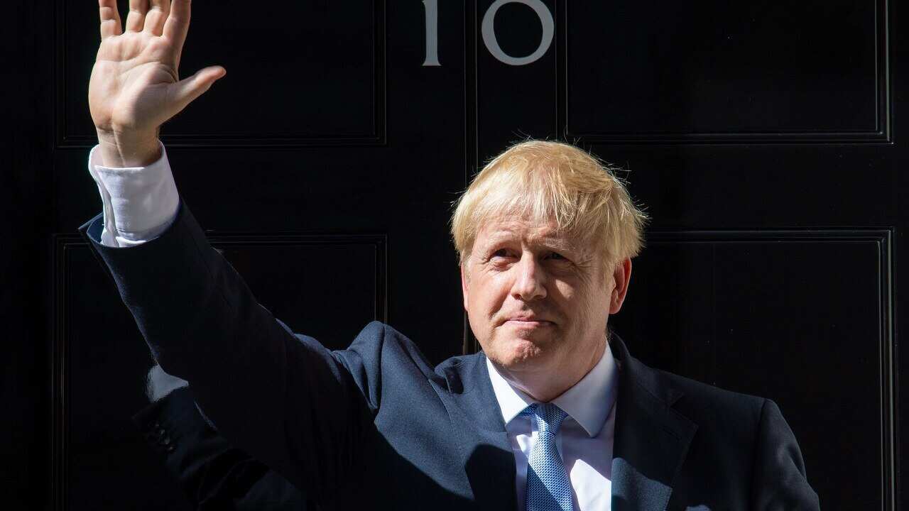 Boris Johnson waves outside 10 Downing Street, London.