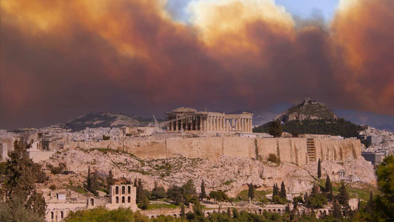 View of the Acropolis and the Parthenon against the background of smoke from fires in Athens, Greece