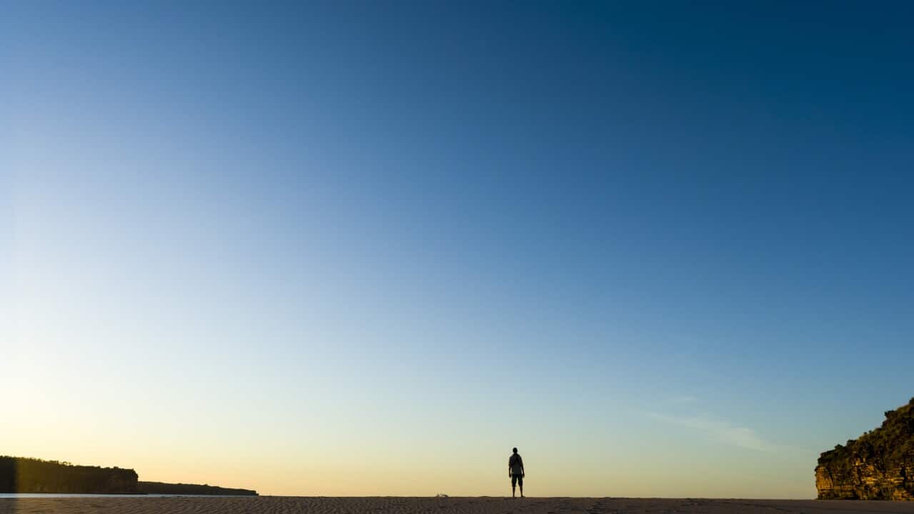 Person standing alone on a beach