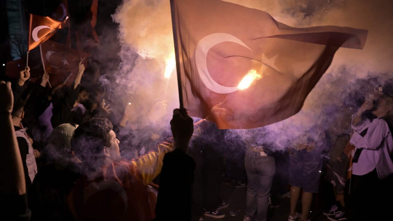 A crowd of people with flags and torches
