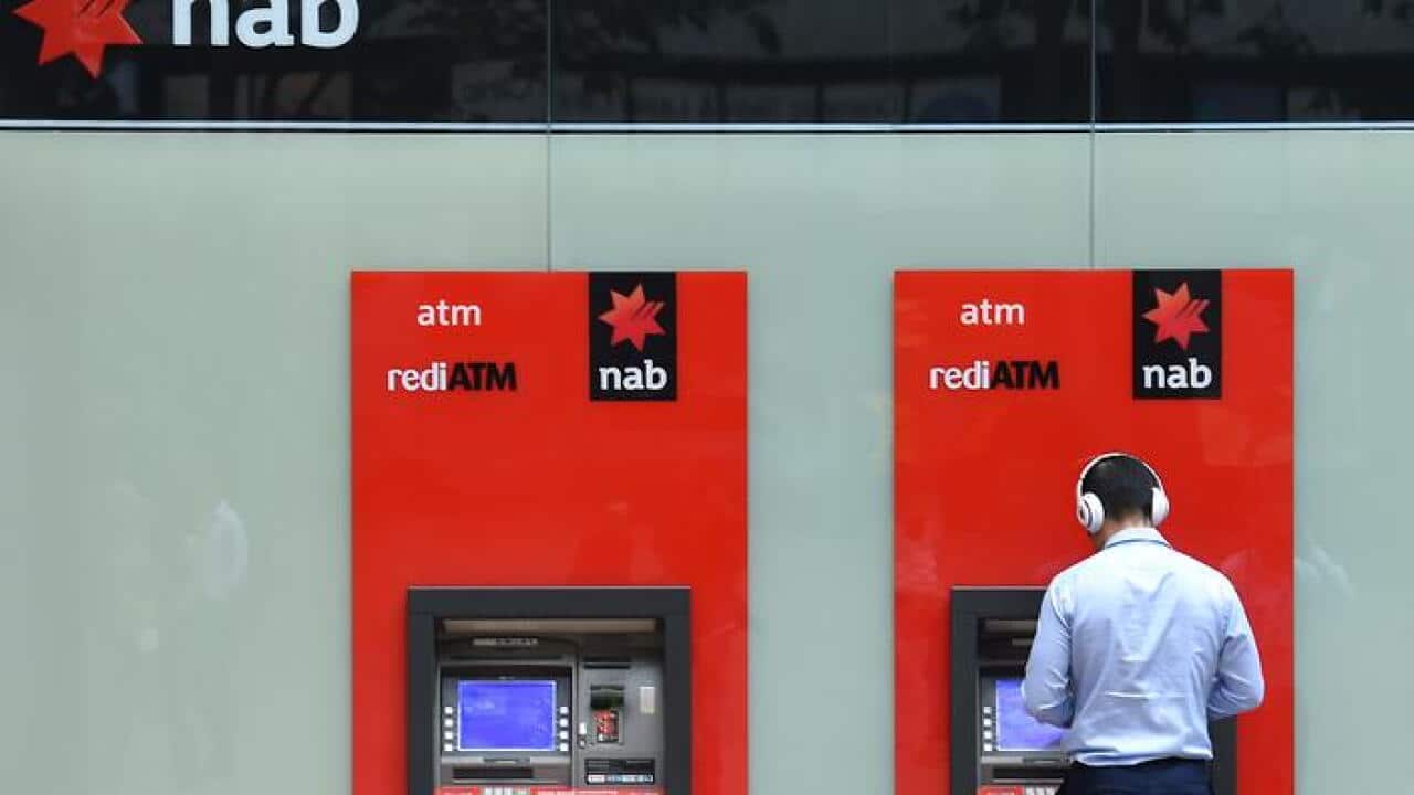 A man uses a National Australia Bank (NAB) ATM in Sydney