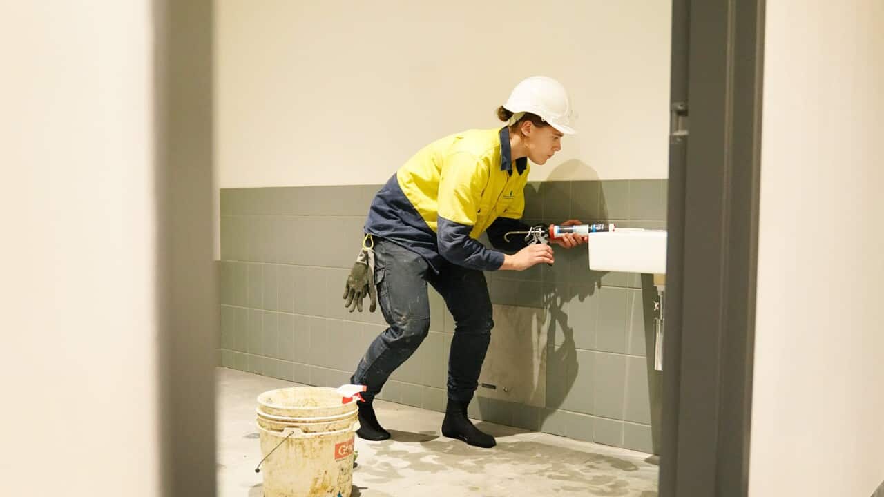 A female footy player plumber at a construction site in Melbourne (AAP).jpg