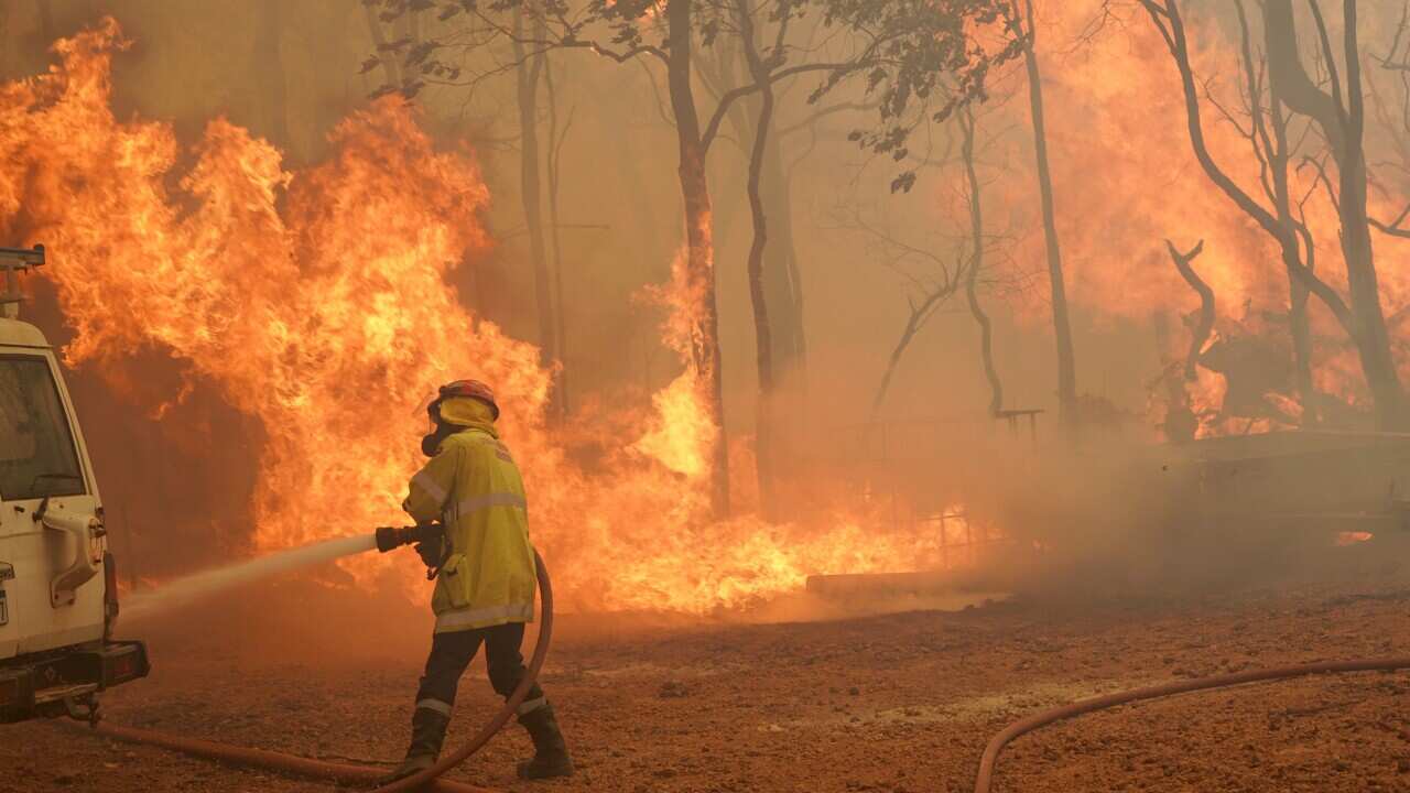 A firefighter attends a fire near Wooroloo, north east of Perth, Australia, on 2 February.