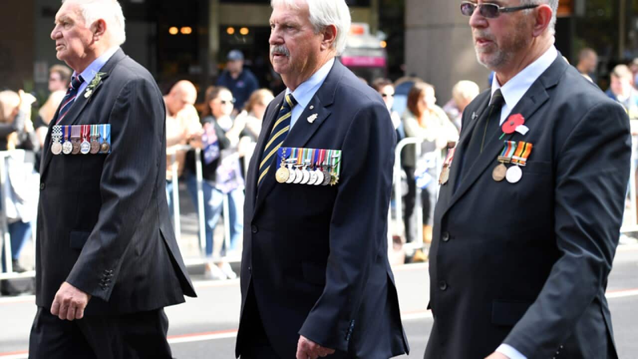 John Haines (C) takes part in the ANZAC Day March
