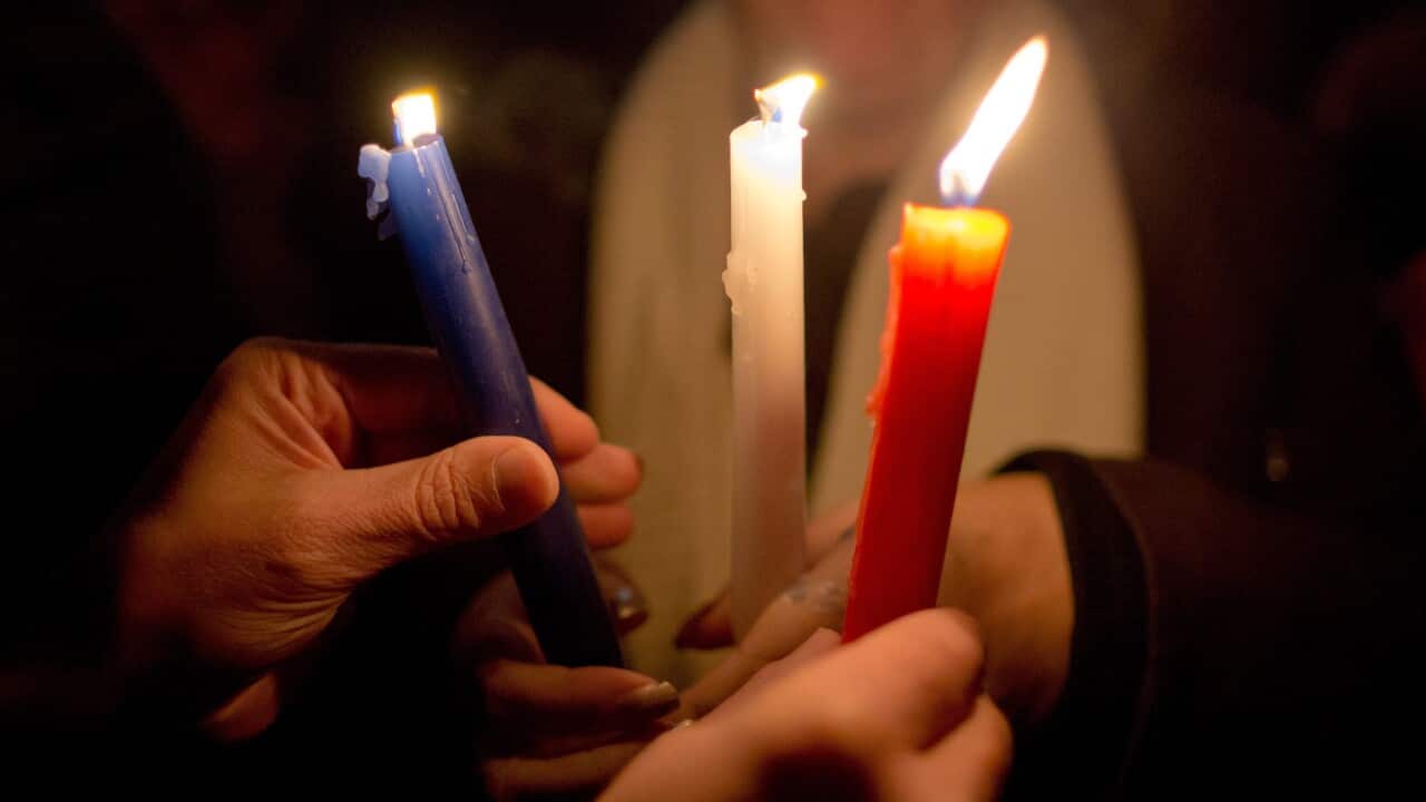 Attendants light candles of the French tri-colour to take part in a silent memorial for the victims of the attacks in Paris in Nuernberg, Germany, 16 November 2015. EPA/DANIEL KARMANN