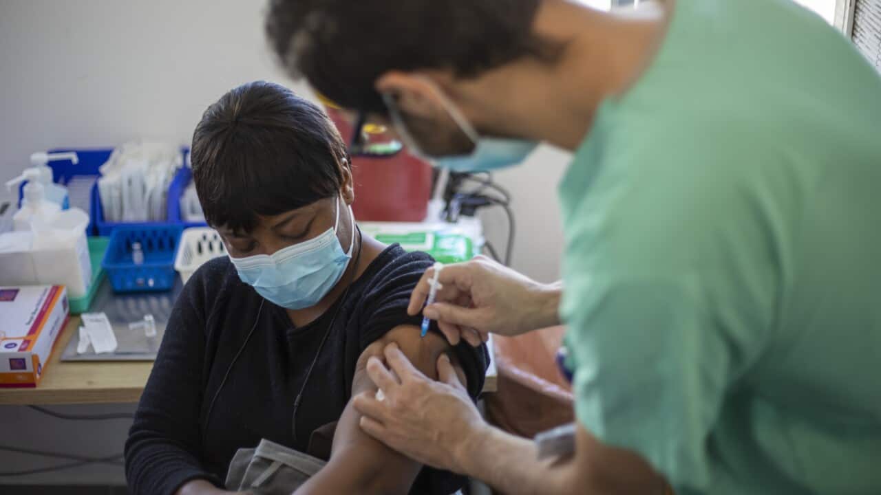 Rachel Albi, a foreign worker from Nigeria, receives her first dose of the Pfizer-BioNTech in Tel Aviv, Israel, Tuesday, 9 February, 2021.