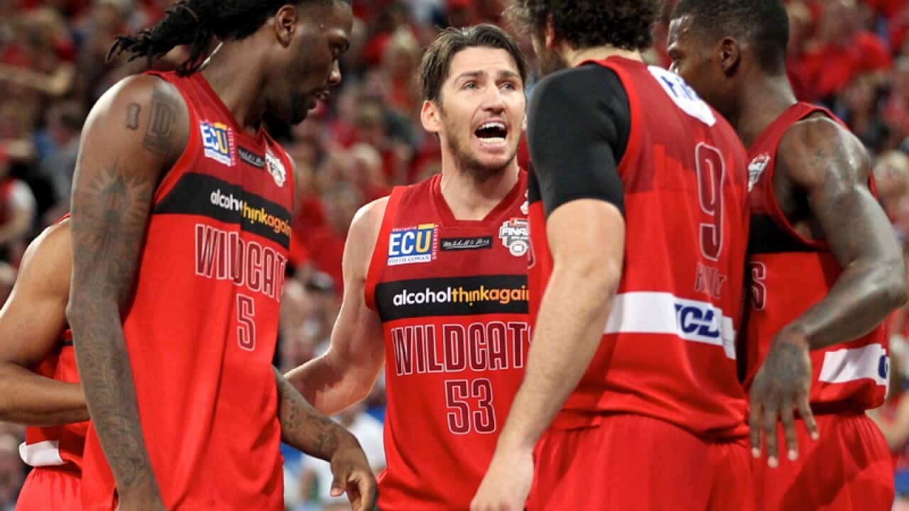 Damian Martin of the Wildcats talks to team mates