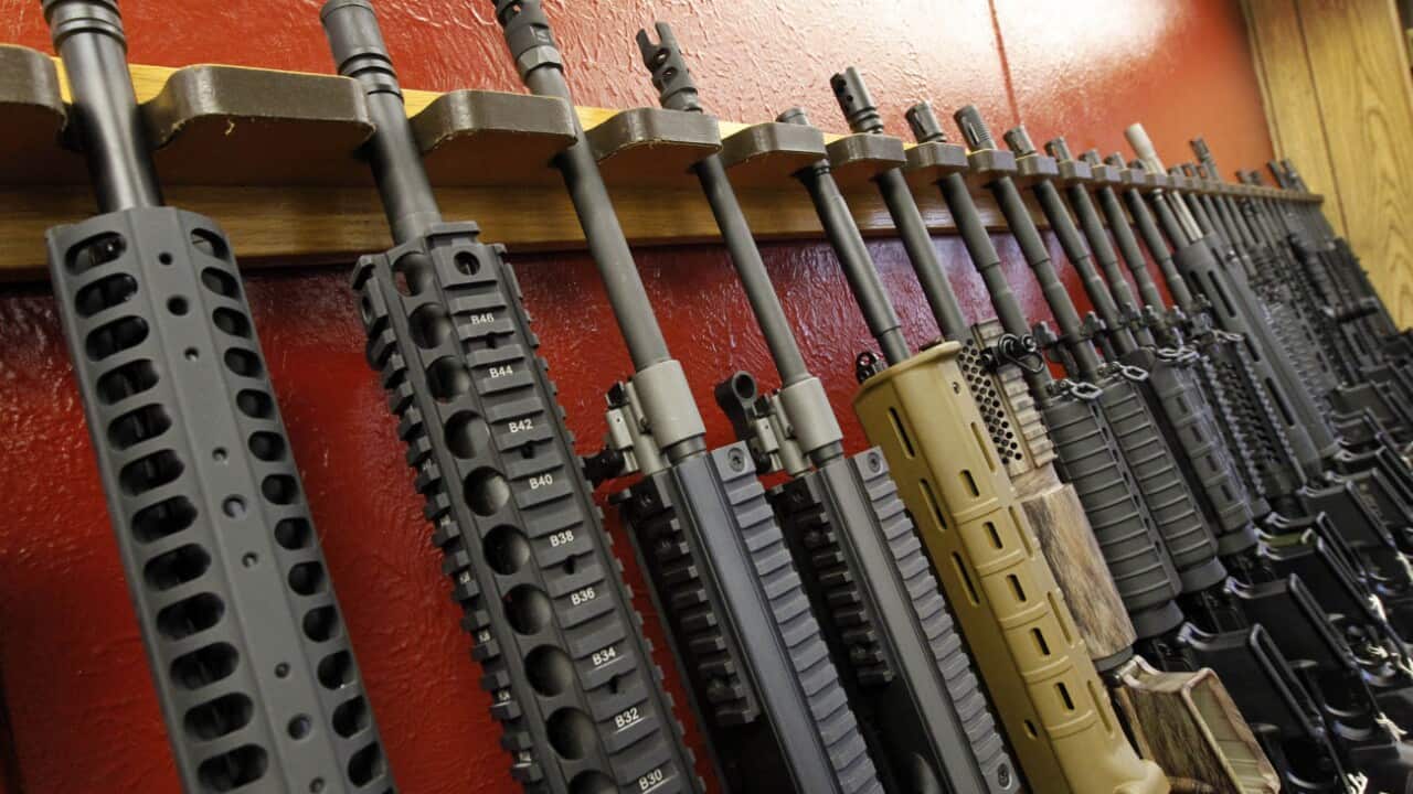 A row of different AR-15 style rifles are displayed for sale at the Firing-Line indoor range and gun shop in Aurora, Colorado.