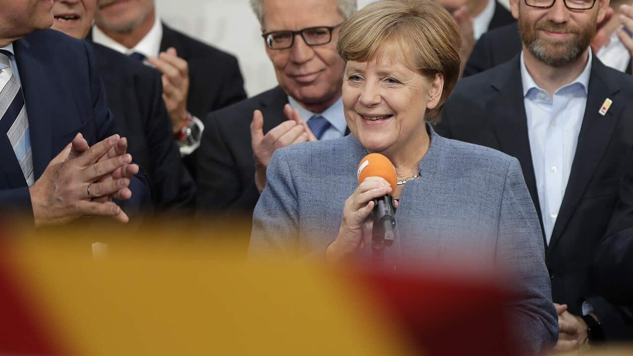 German Chancellor Angela Merkel smiles at the HQ of the CDU in Berlin, Germany, Sunday, Sept. 24.
