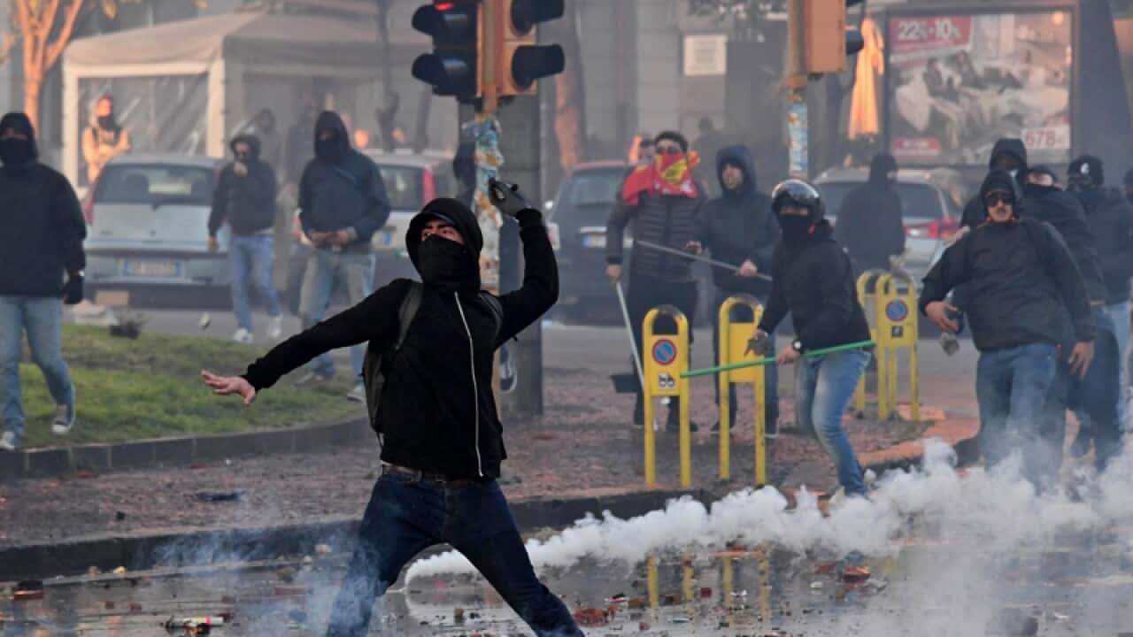 Protesters clash with police during a protest in Naples