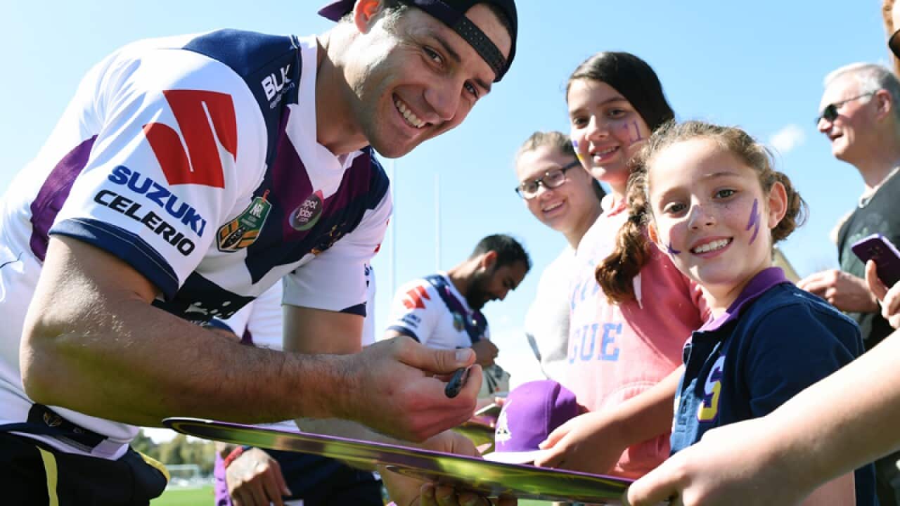Melbourne Storm NRL player Cooper Cronk signs autographs