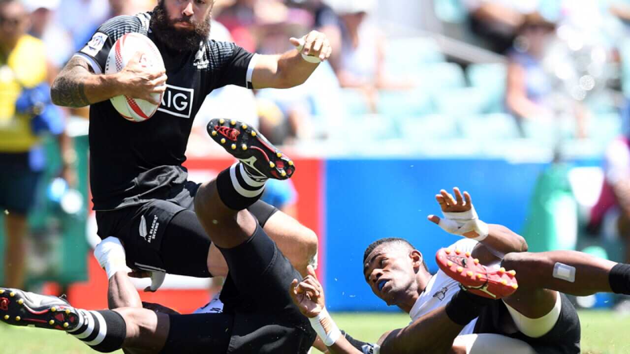 DJ Forbes of New Zealand (L) is tackled by Nacanieli Labalaba (R)