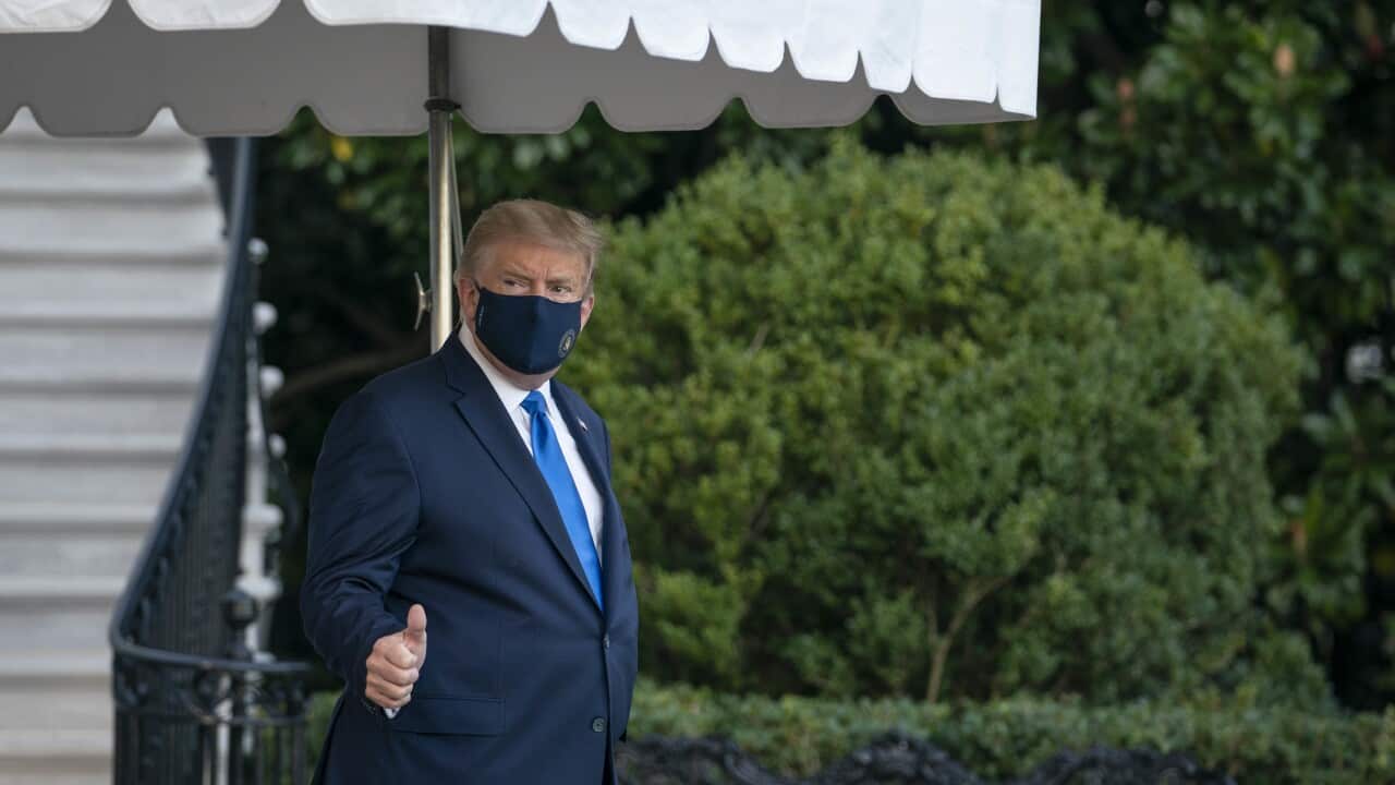 Donald Trump walks along the South Lawn of the White House before boarding Marine One