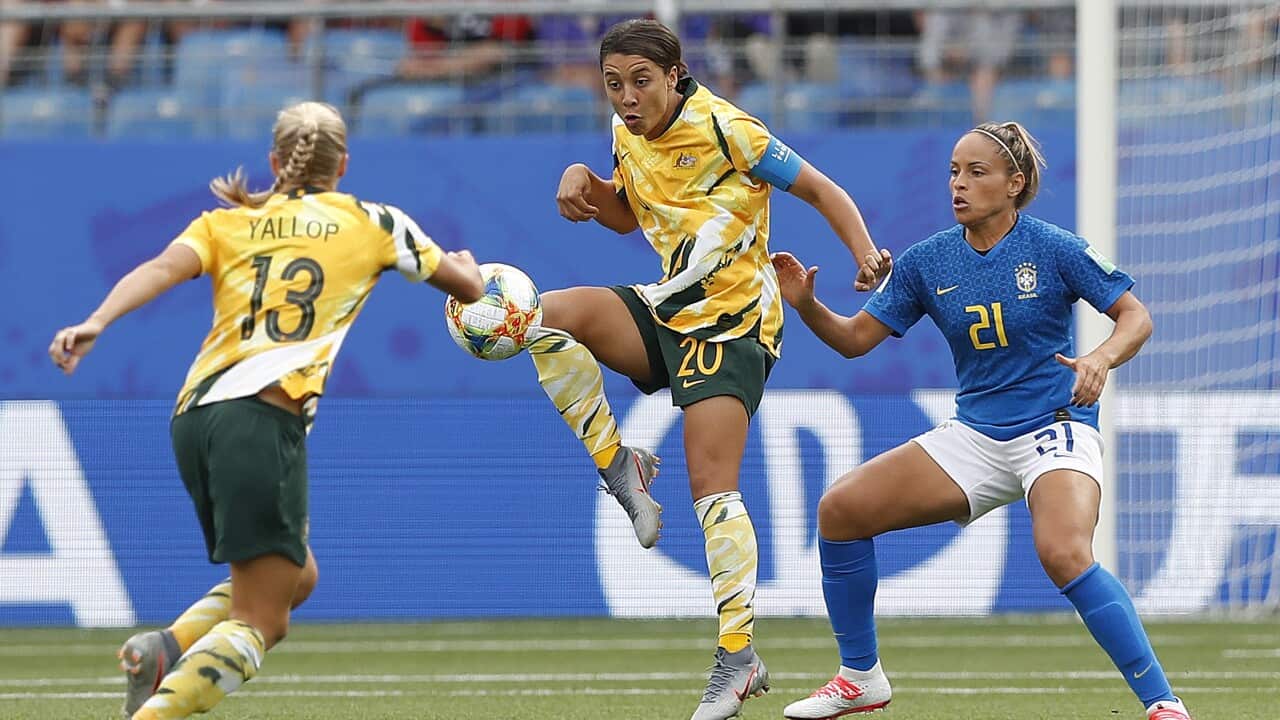 Monica (R) of Brazil in action against Sam Kerr of Australia during the preliminary round match between Brazil and Australia.