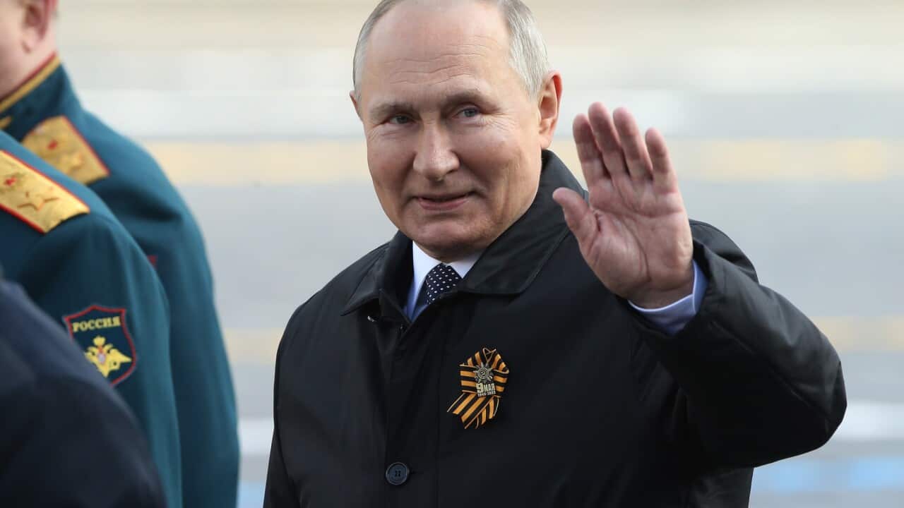 Russian President Vladimir Putin waves during the Victory Day Parade at Red Square on 9 May 2022 in Moscow, Russia.