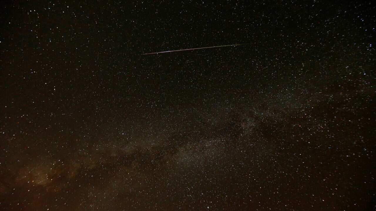 A meteor streaks across the sky in the early morning during the Perseid meteor shower in Ramon Crater near the town of Mitzpe Ramon