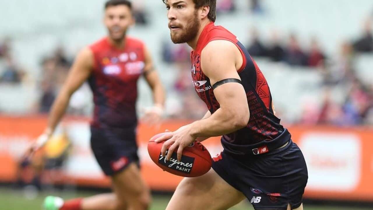 Jack Viney of the Demons holds the ball.