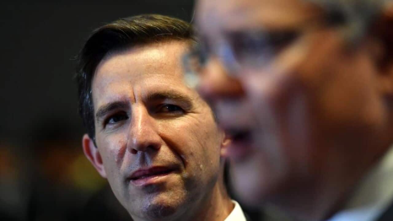 Australia's Minister for Trade Simon Birmingham (L)