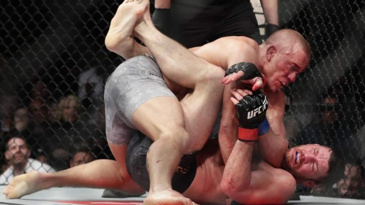 Georges St-Pierre holding Michael Bisping down