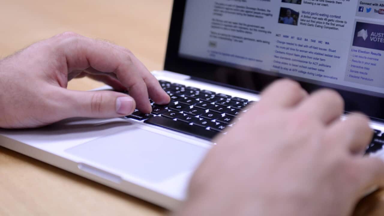 A man uses a laptop computer