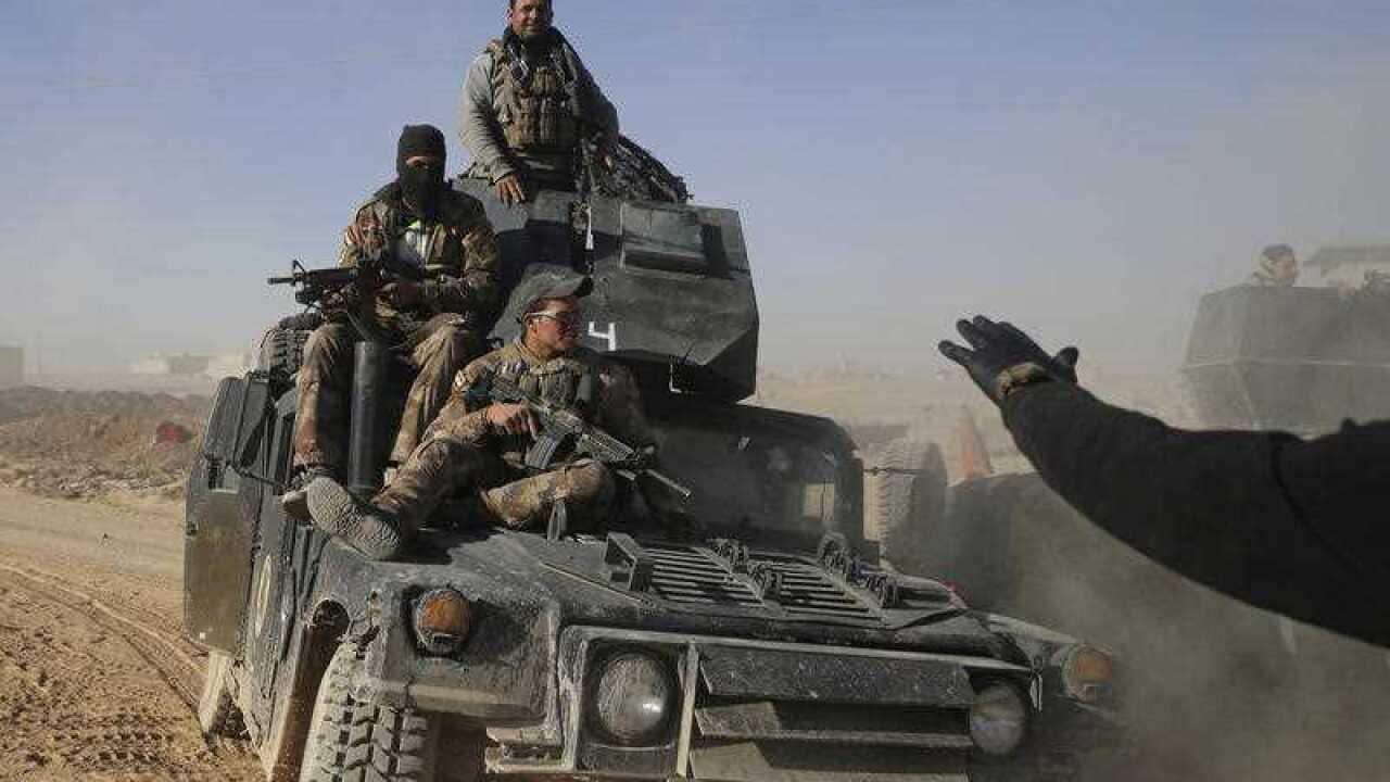 Iraqi special forces soldiers sit on their humvee, as they arrive to relieve soldiers returning from the battlefield, in the Al-Samah front line neighborhood