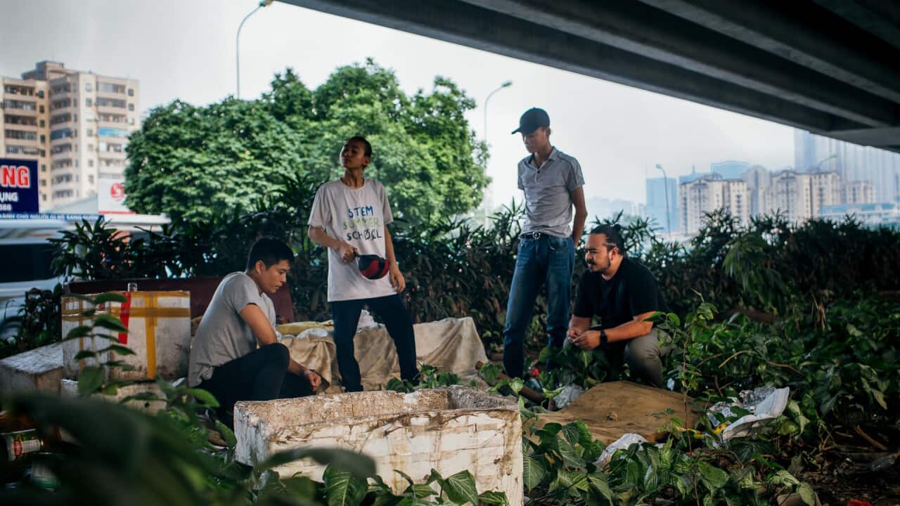 Vi and Adam visit Viet and Tuan where they were living under a bridge.