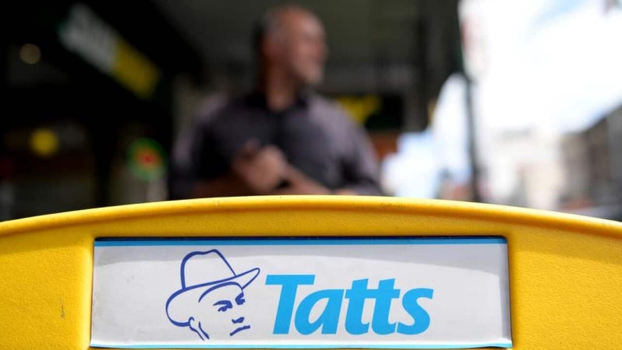 close-up of Tatts signage on newsagency / shop counter