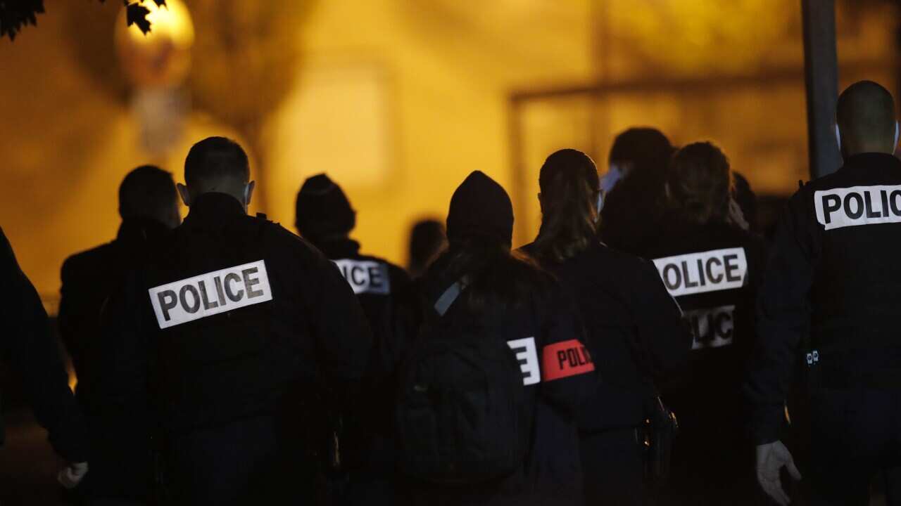 French police officers gather outside the high school