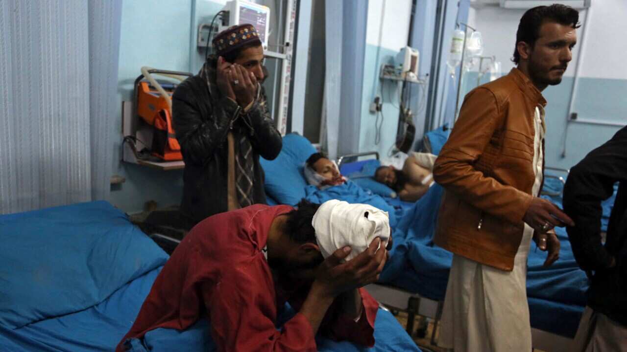 Injured men receive treatment at a hospital after a suicide bombing in Kabul