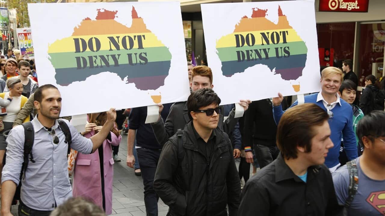 Perth residents with signs supporting the legalisation