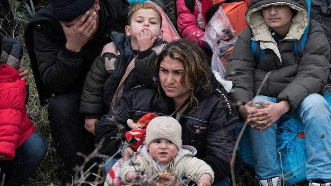 Migrants wait before travelling to Greek island of Lesbos, near Ayvacik