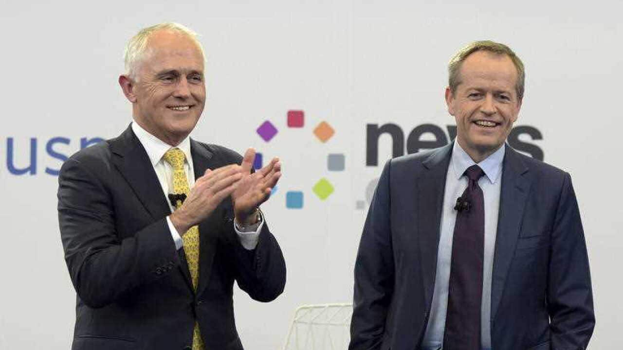 Prime Minister Malcolm Turnbull and Australian opposition leader Bill Shorten react at the end of a leaders debate hosted by Facebook Australia and News.com.au