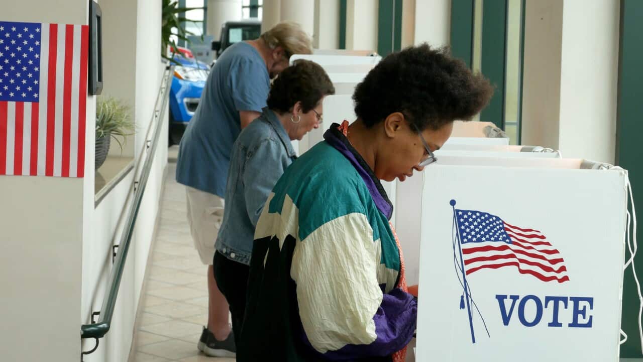 Voters mark their ballots at the Santa Monica Jeep polling station as Californians go to the polls in California's primary election.