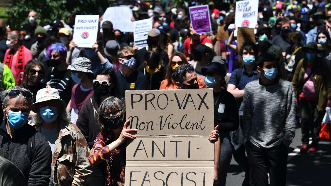 Members of The Campaign Against Racism & Fascism group participate in a counter protest against anti-vaxxers in Melbourne.