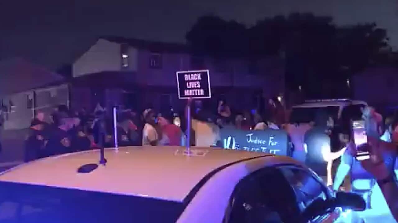 Protesters gather near the site of a police shooting, Sunday, August 23 in Kenosha, Wisconsin.