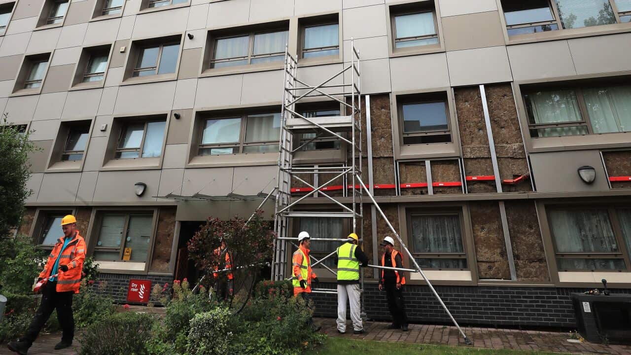 Workmen start to remove cladding on Hornchurch Court, Hulme, Manchester