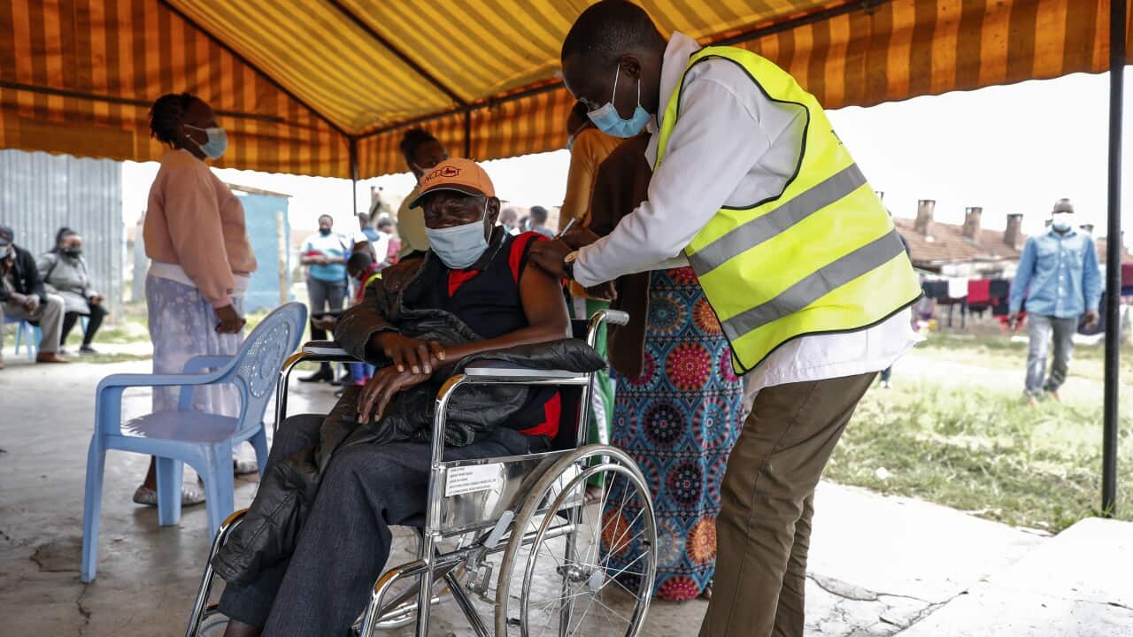 A Kenyan man receives a dose of the AstraZeneca coronavirus vaccine donated by Britain, at the Makongeni Estate in Nairobi.