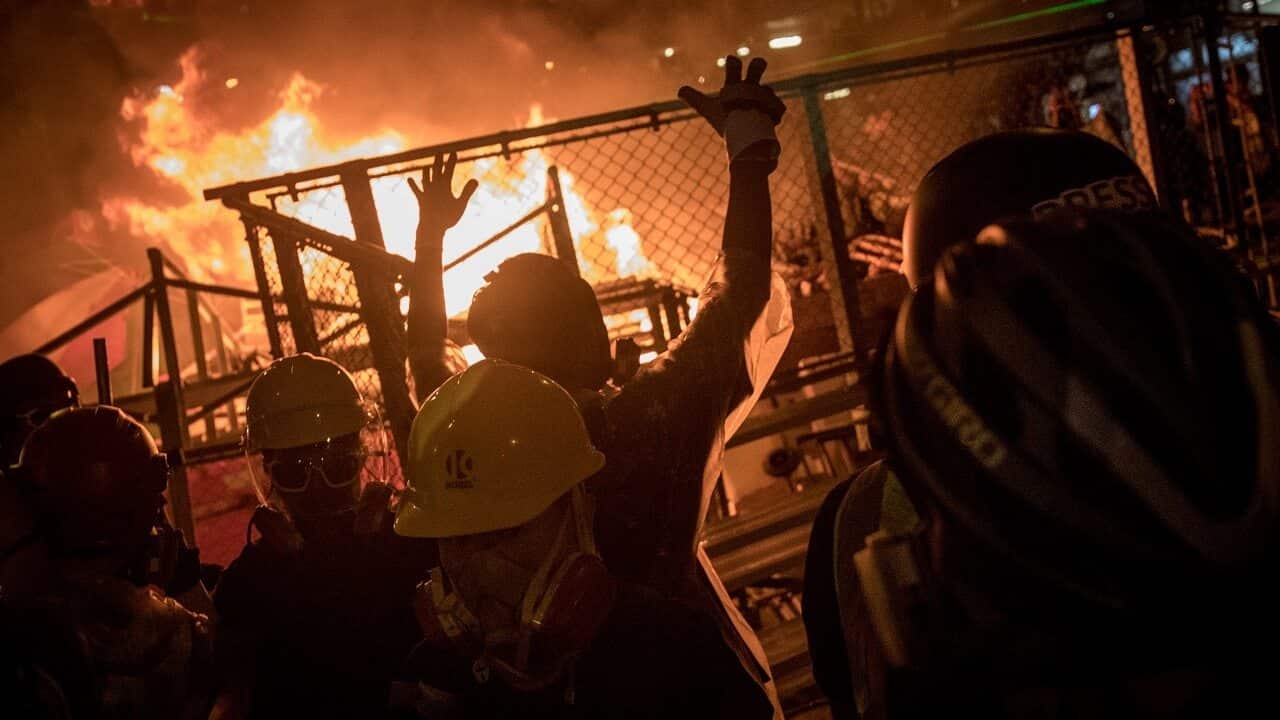 Protesters celebrate after setting fire to a makeshift barricade on Saturday.