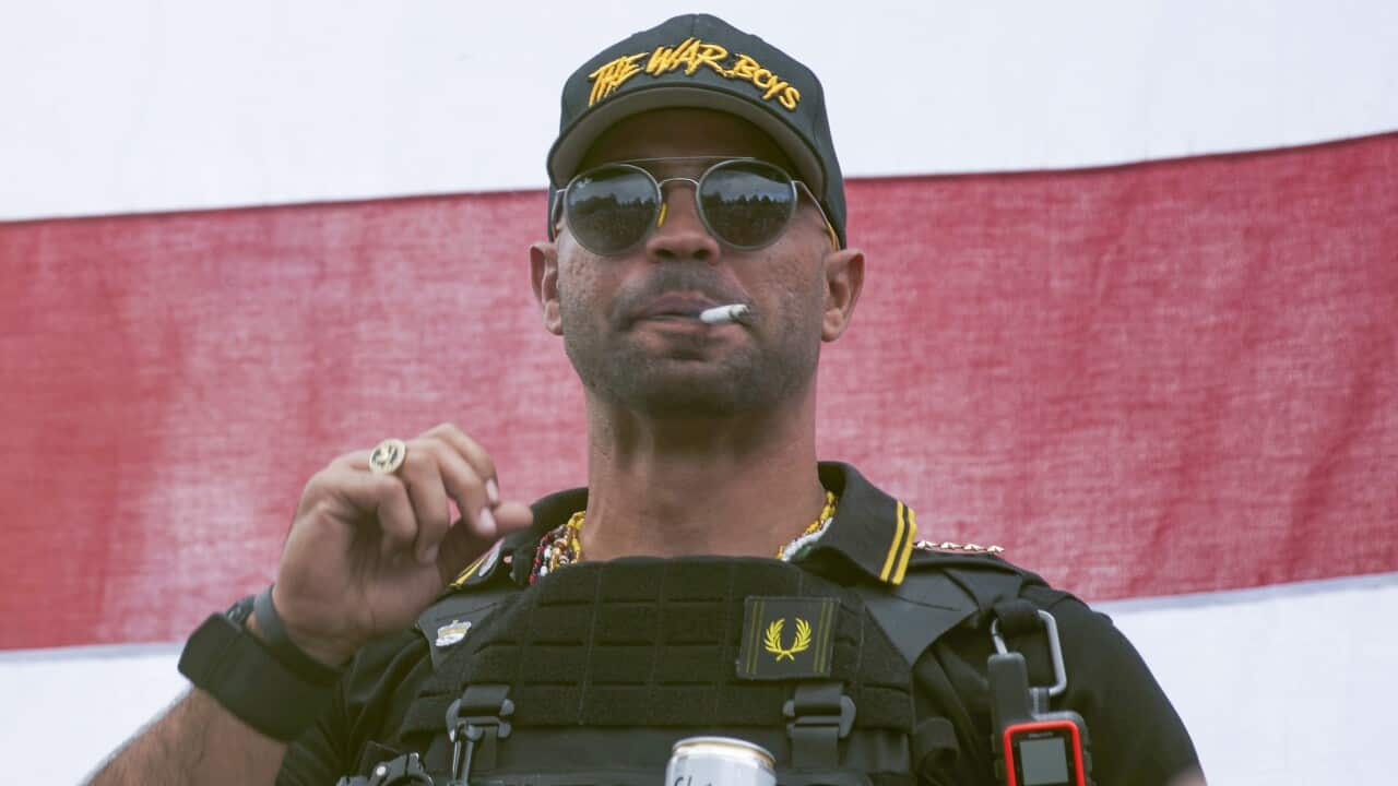 Proud Boys leader Henry "Enrique" Tarrio wears a hat that says The War Boys during a rally in Portland