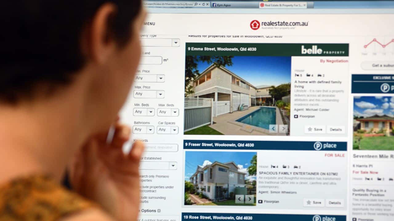 A woman looks at real estate advertising on an internet