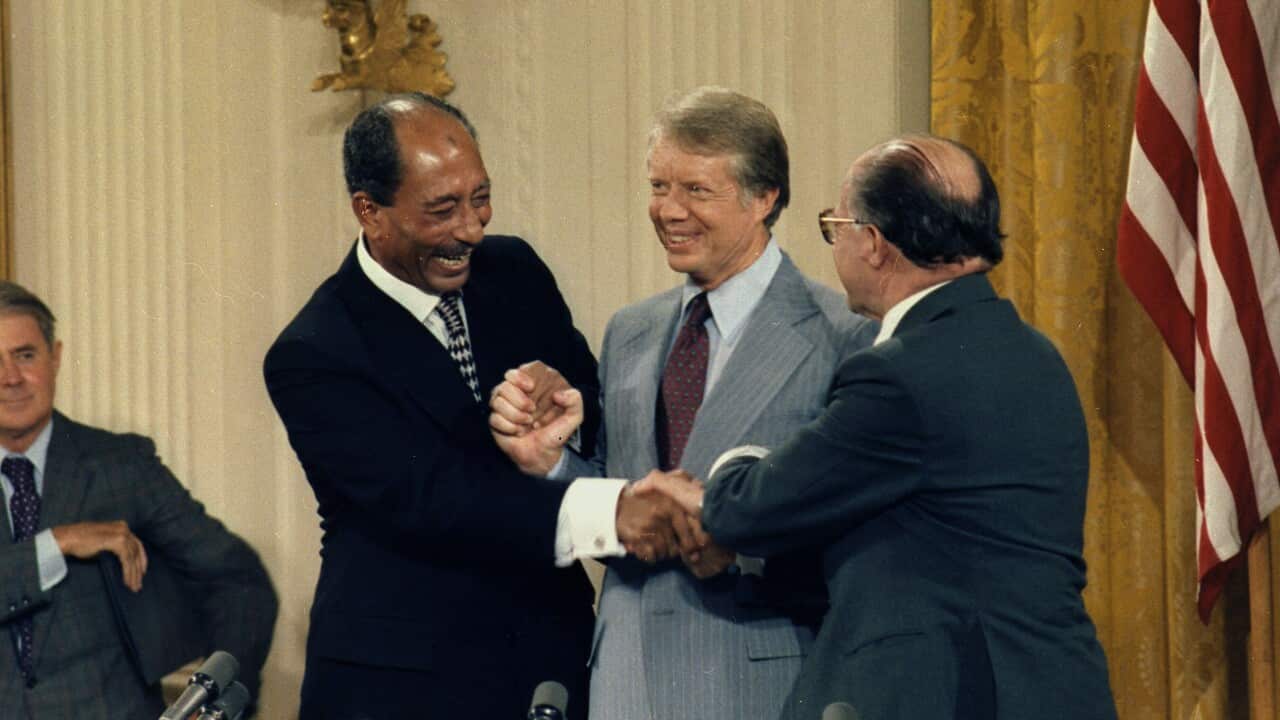 Anwar Sadat, Jimmy Carter and Menachem Begin at the Camp David Accords Signing Ceremony. ca. 09/17/1978