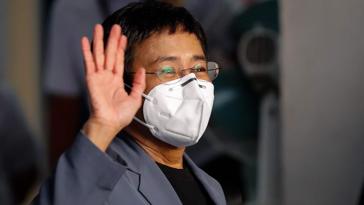 Maria Ressa, CEO and Executive Editor of online news site Rappler, gestures to the media upon her arrival at court in Manila, Philippines, 15 June 2020.