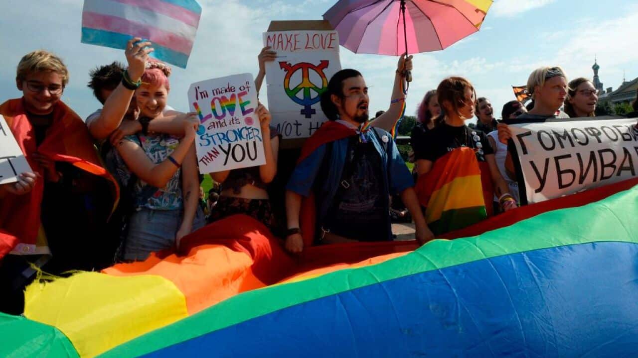 People wave gay rights' movement rainbow flags during the gay pride rally in Saint Petersburg, on Agust 12, 2017. / AFP PHOTO / OLGA MALTSEVA (Photo credit should read OLGA MALTSEVA/AFP/Getty Images)