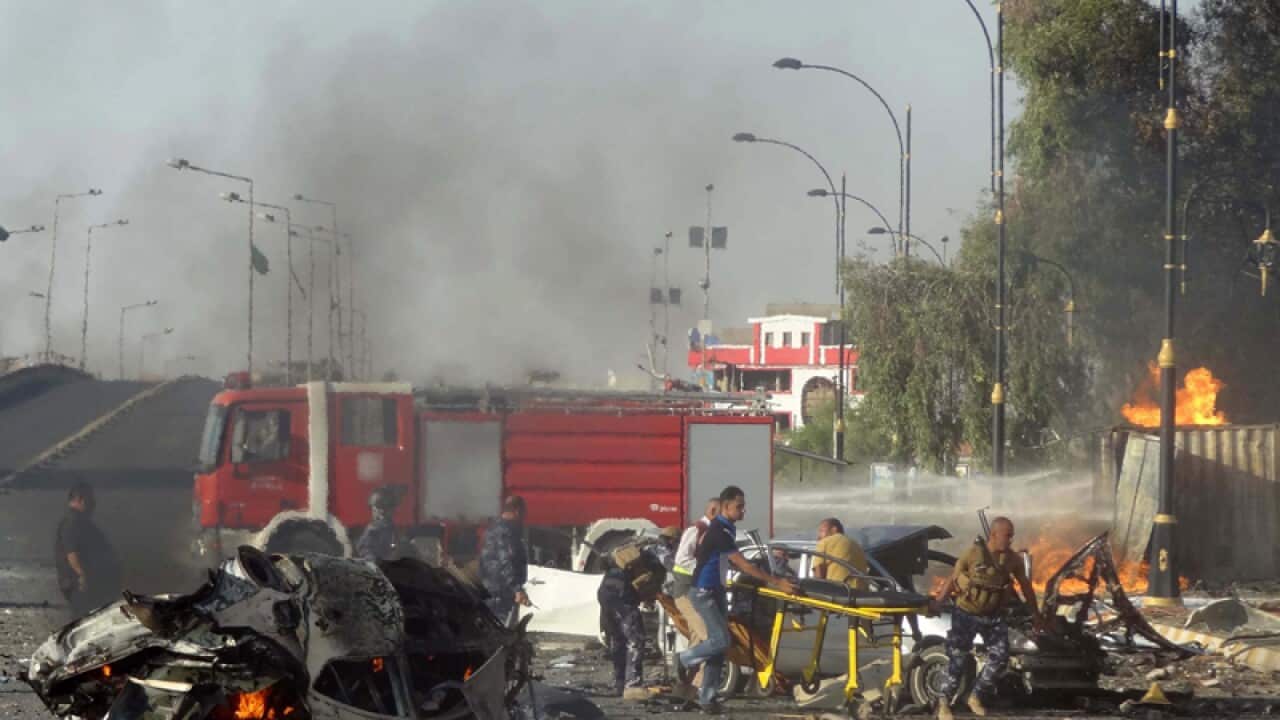 Emergency responders work at the scene of an explosion in Kurkuk