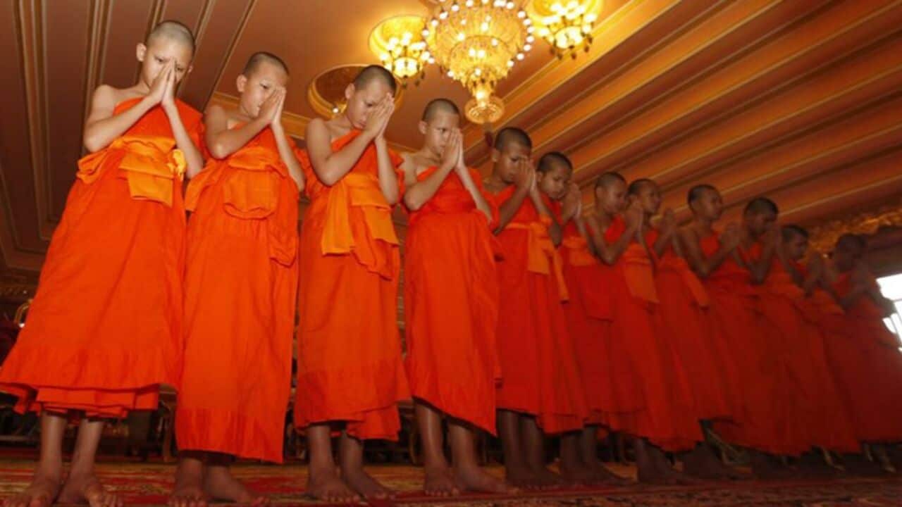 Members of the Wild Boars soccer team pray during a ceremony of service as novice Buddhist monks in Mae Sai, Thailand on August 4.