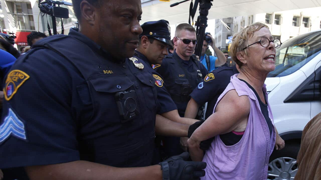 Police take away a woman in Cleveland