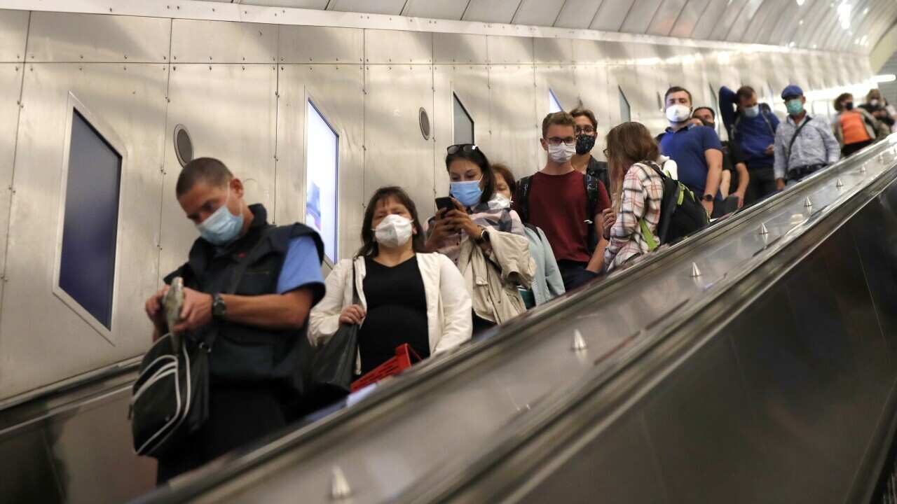 People wearing face masks ride an escalator in subway in Prague, Czech Republic, Thursday, 17 September, 2020.